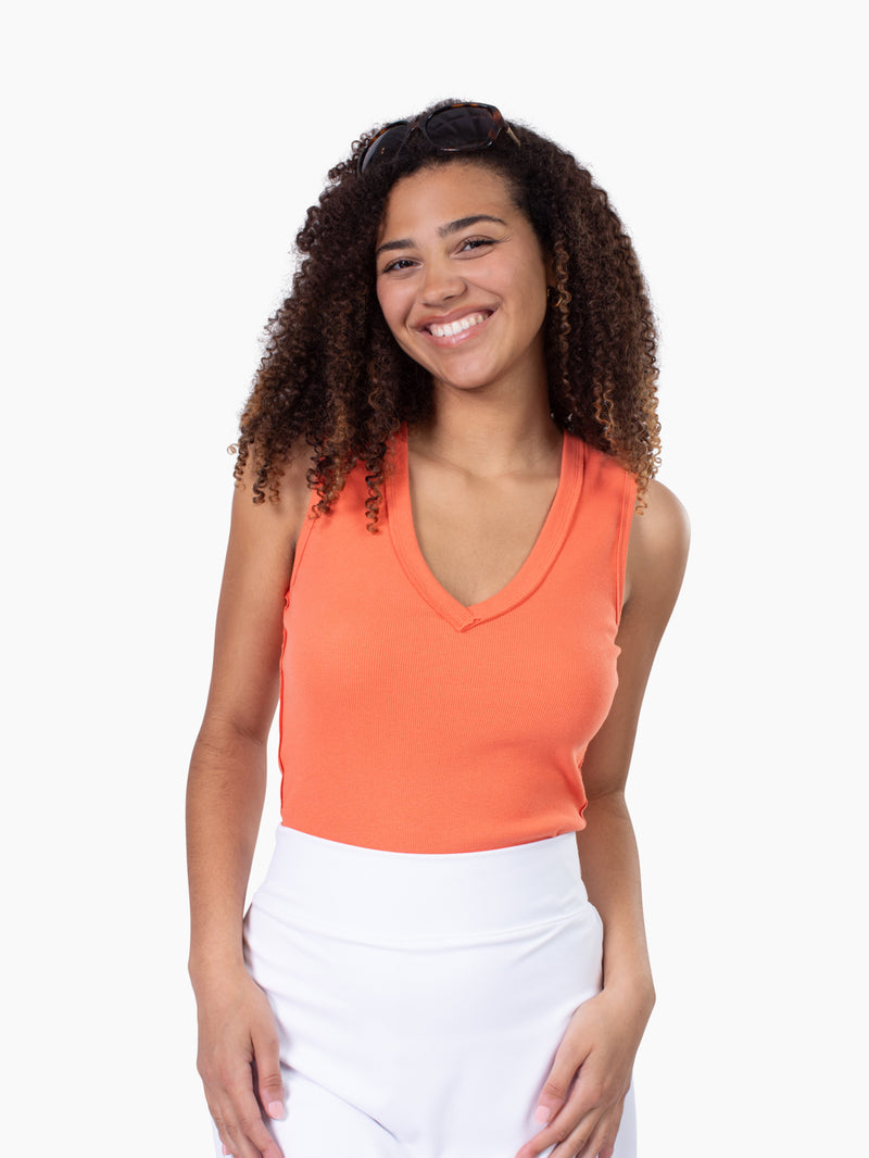 Tall woman wearing Riviera ribbed v-neck tank in coral