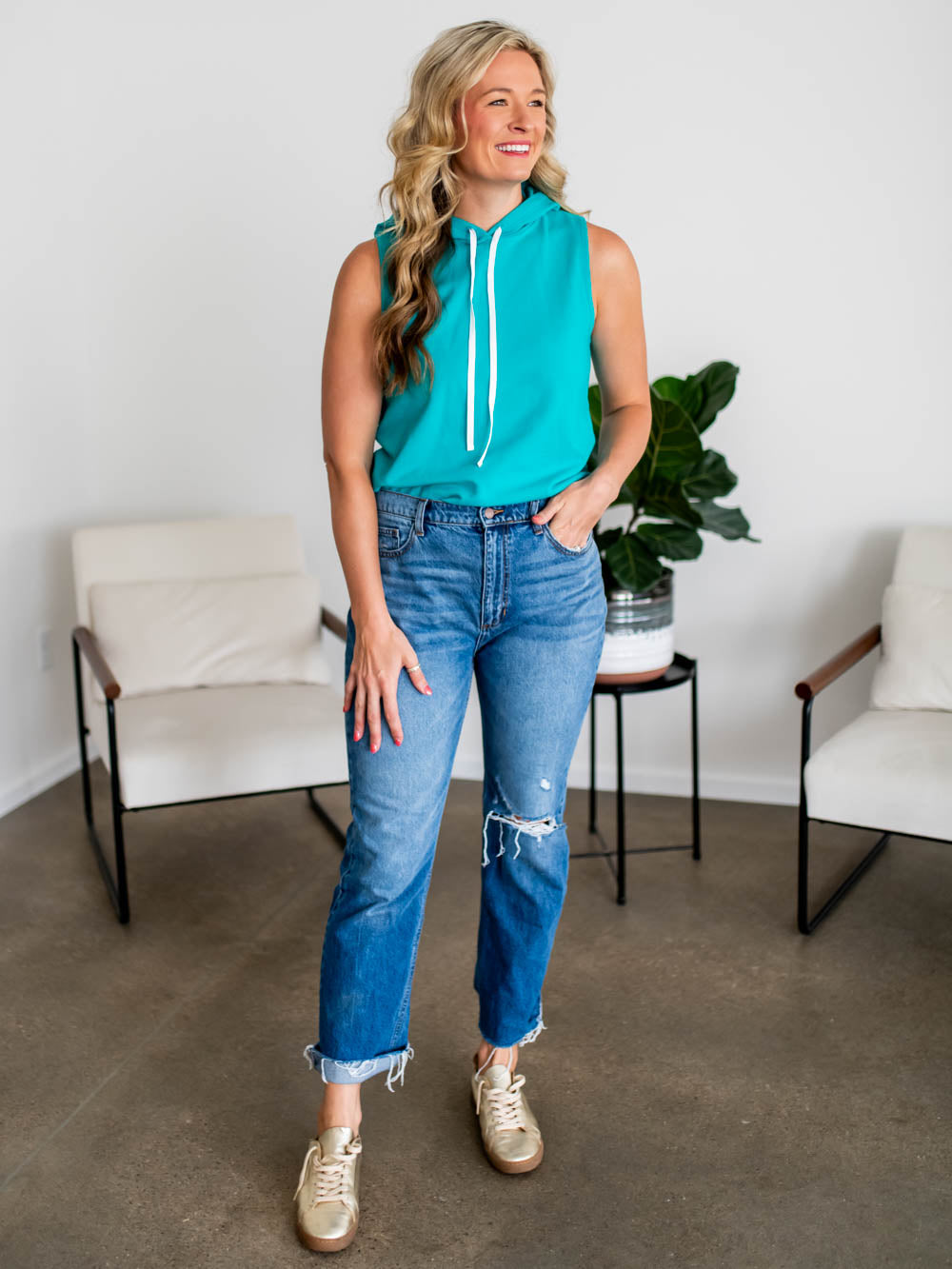 Sleeveless hoodie tank top for tall women in bright turquoise color