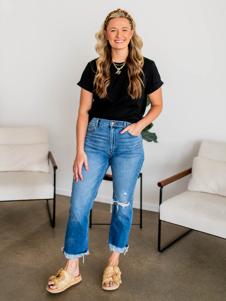 Front view of frame tee in black on tall model