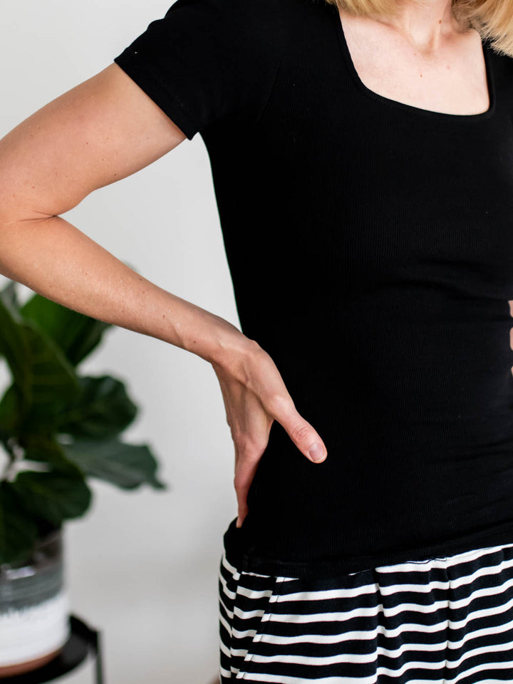 Side view of black square neck ribbed tee on tall model