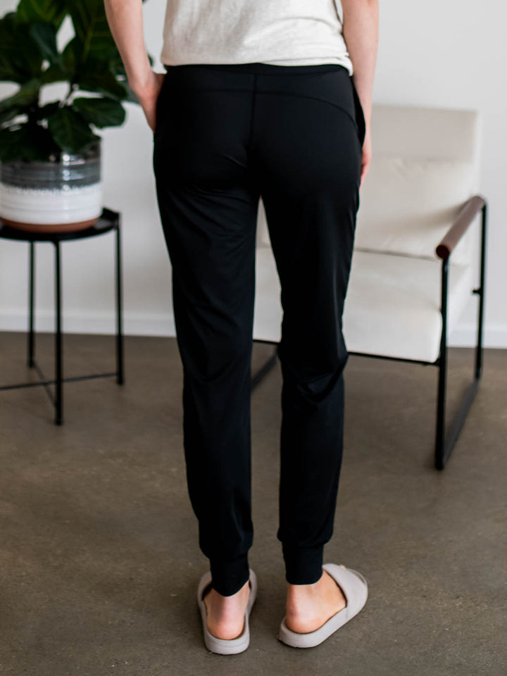 Back view of tall black joggers with cuffed ankle and smooth waistband fit