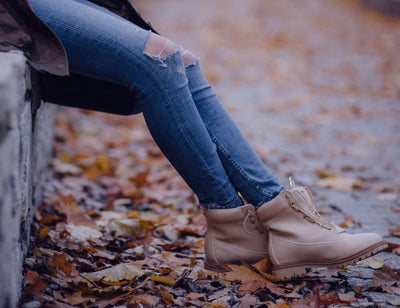 Sitting in tall jeans and boots