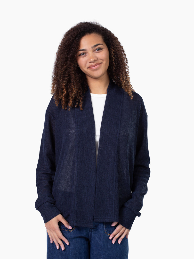 Tall woman wearing Cove Cardigan in navy