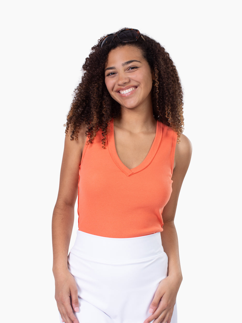 Tall woman wearing Riviera ribbed v-neck tank in coral