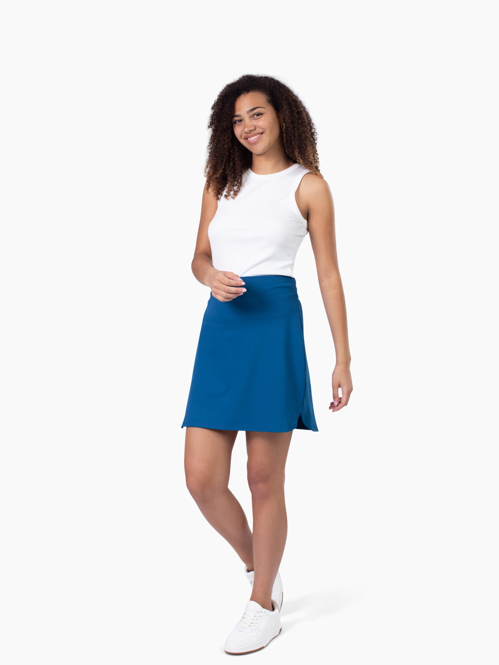 Tall woman wearing Rally athletic skort in navy teal