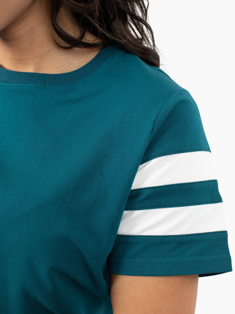 tall woman wearing deep teal stripe sleeve t-shirt