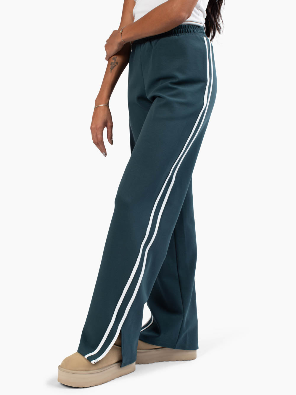 Side view of tall sweatpants with white lines down side