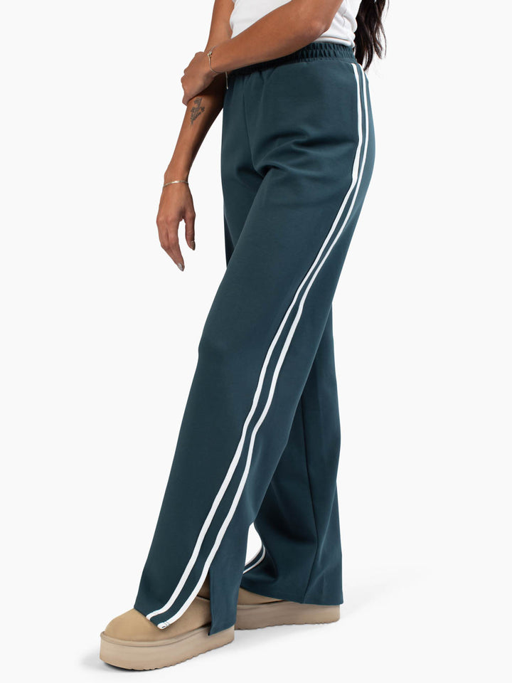 Side view of tall sweatpants with white lines down side