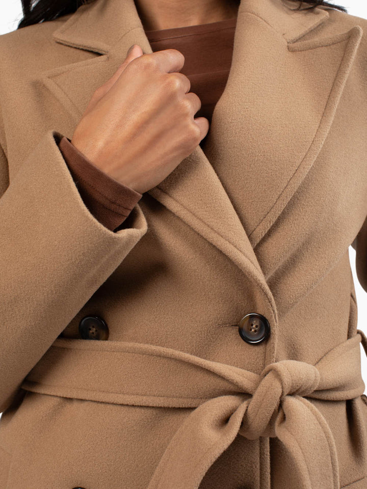 Close-up of tailored camel coat for tall women