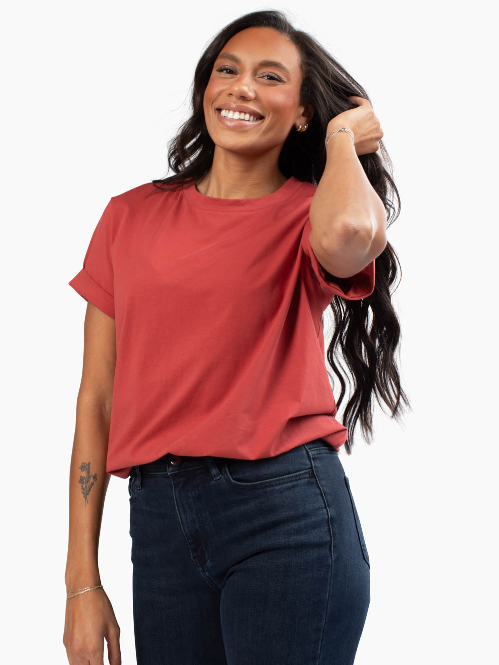 Front view of frame tee in apple cider tucked into jeans on tall model