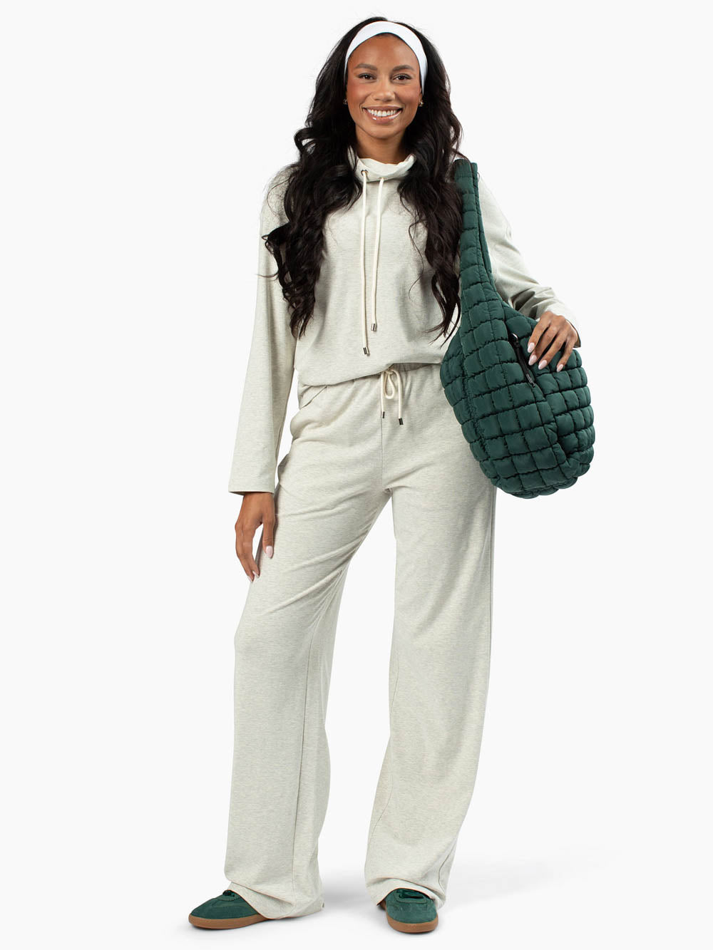 Tall woman wearing Mysa Lounge Set with funnel neck top and wide-leg pants