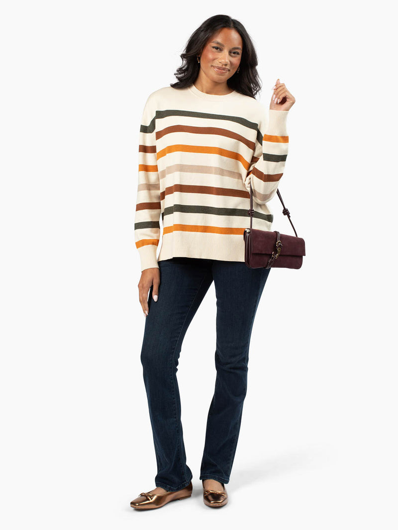 Tall woman wearing Solvi striped sweater with fall tones
