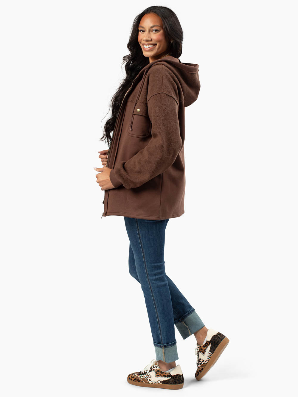 Side profile of tall hoodie in brown with longer sleeves and body