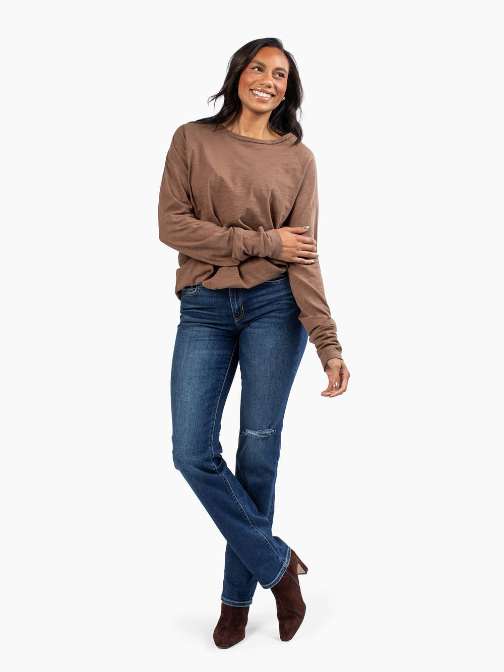 Front view of malley long sleeve tee in brown tucked into jeans on tall model