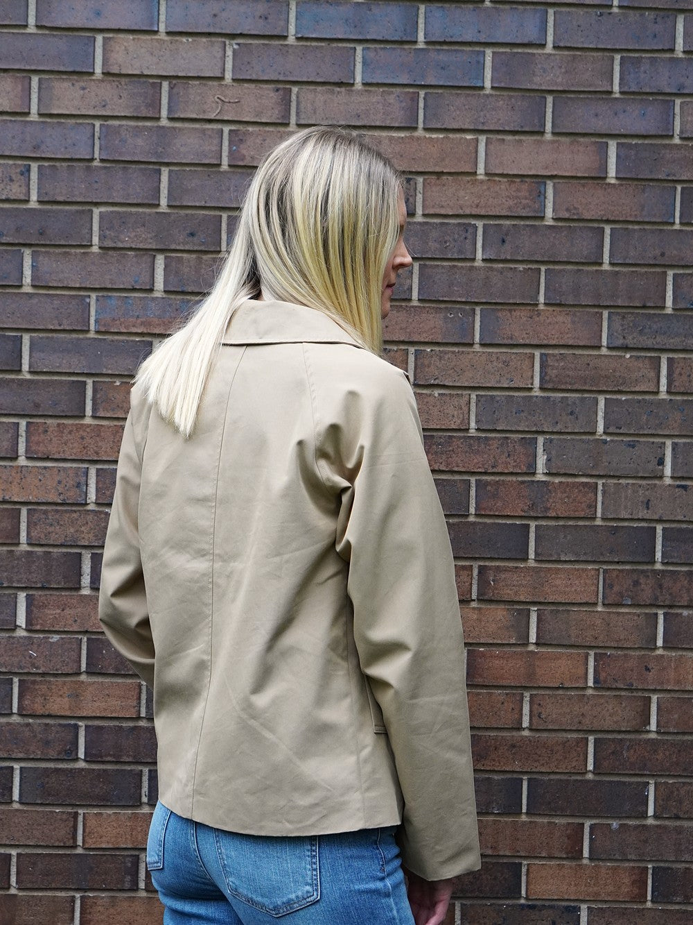 Campbell Short Trench Jacket for tall women in Khaki, back view in natural daylight