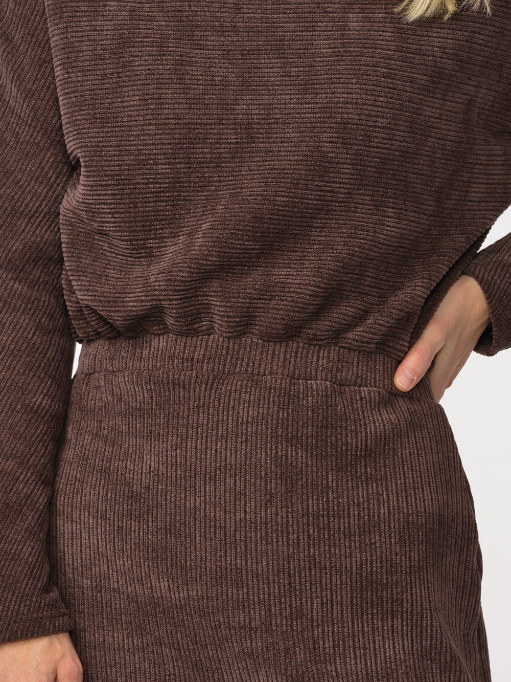Close-up of the Annika dress's velvety ribbed knit and waist detail