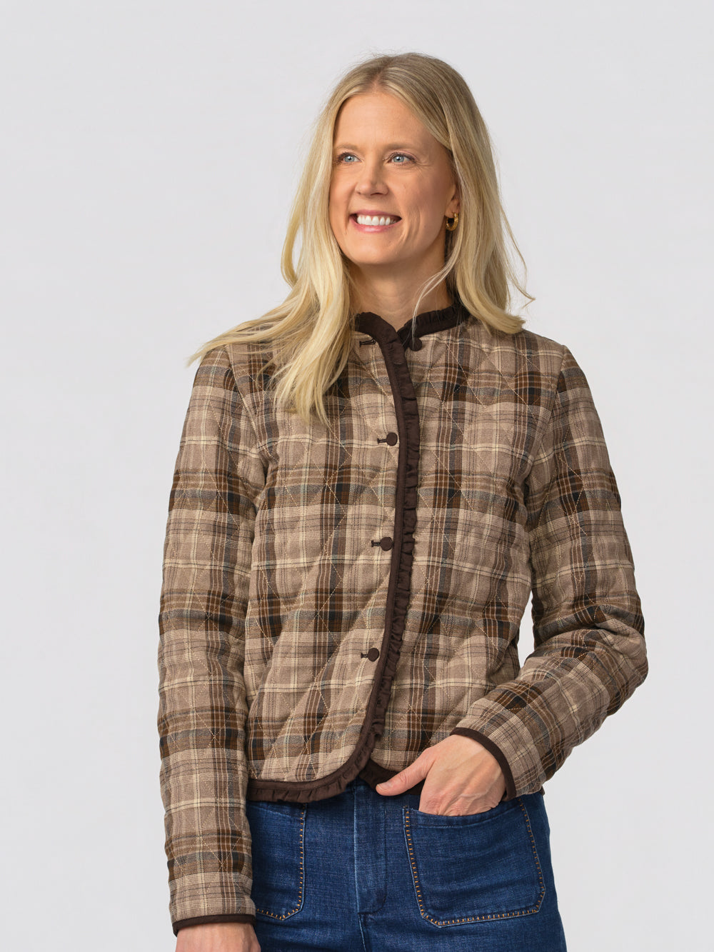 Close-up of the Eloise plaid jacket's ruffle trim, brown piping and button front