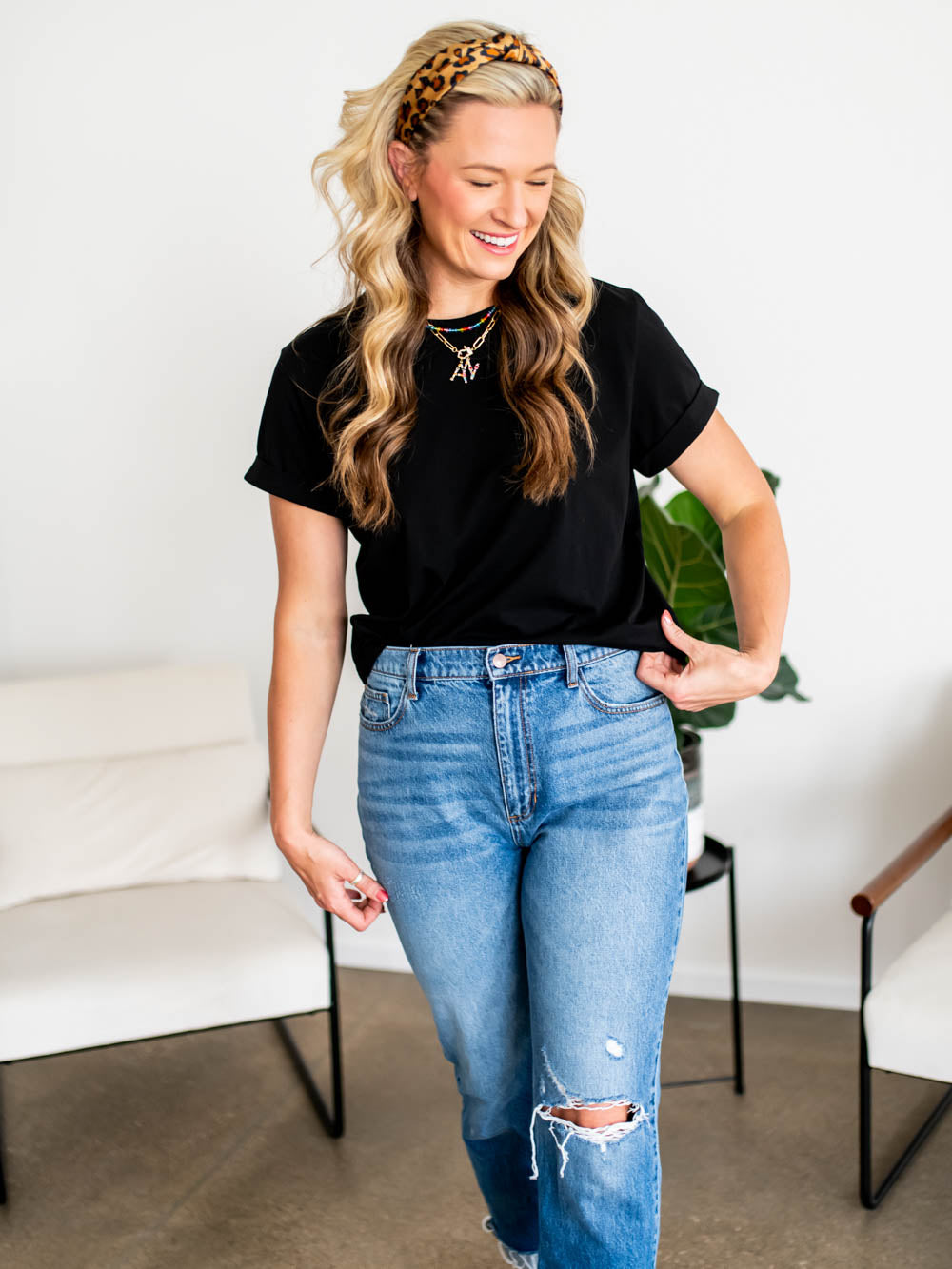 Tall woman wearing black frame tee with cuffed sleeves and relaxed fit