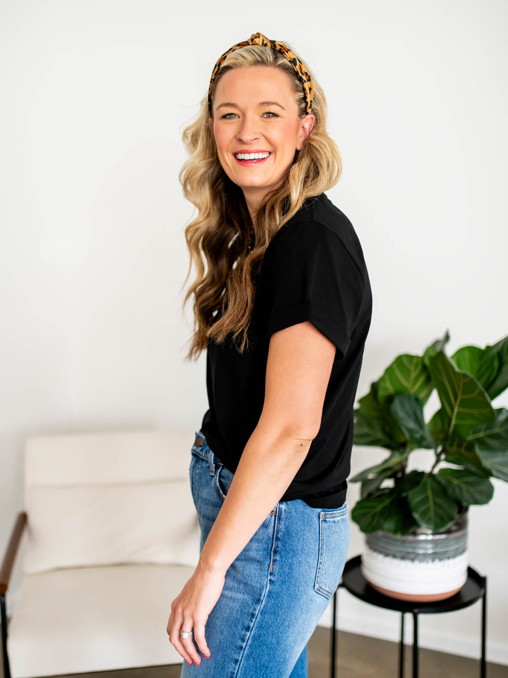 Side profile of tall model wearing black-colored frame tee