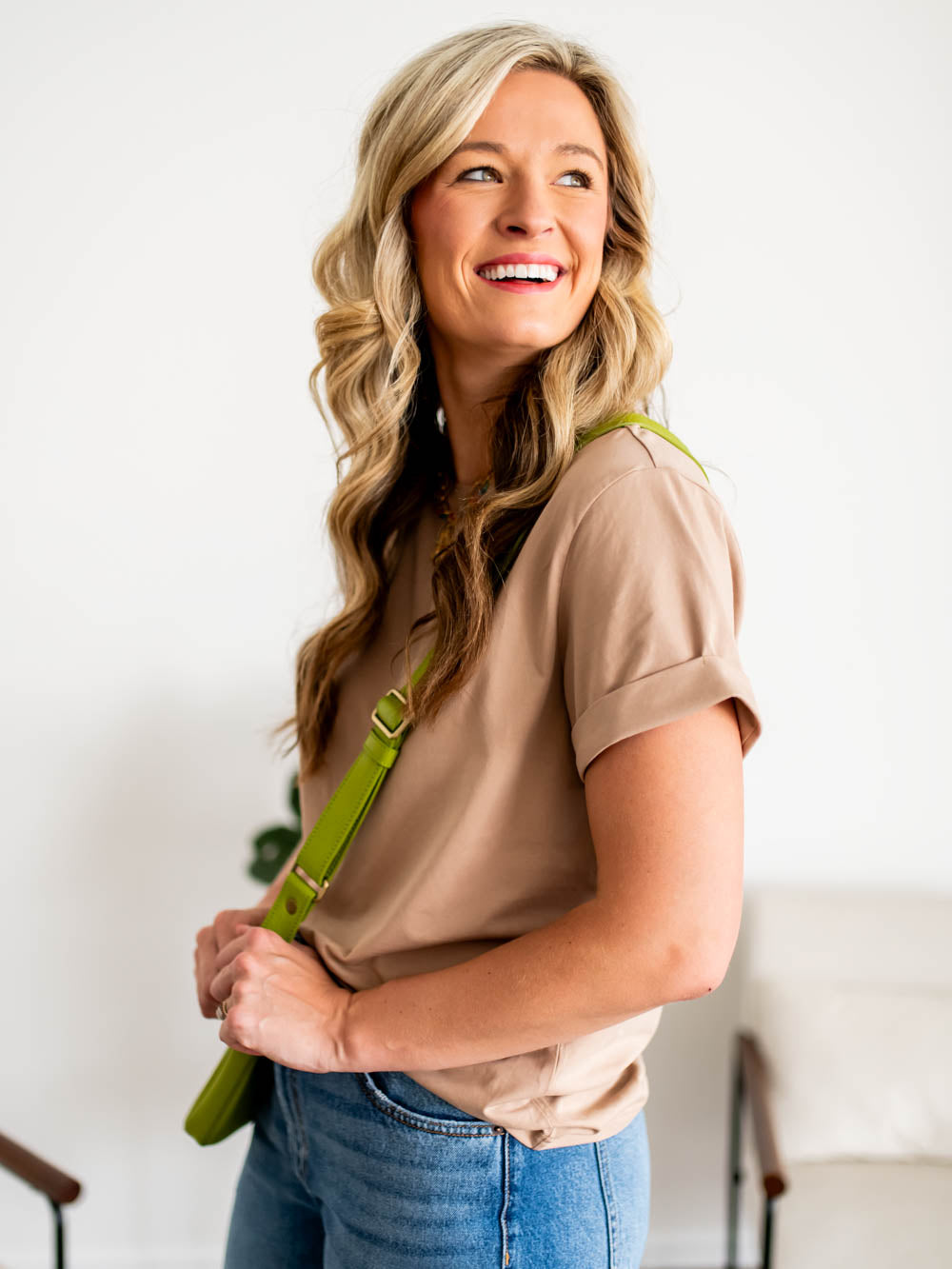 Side profile of tall model wearing latte-colored frame tee