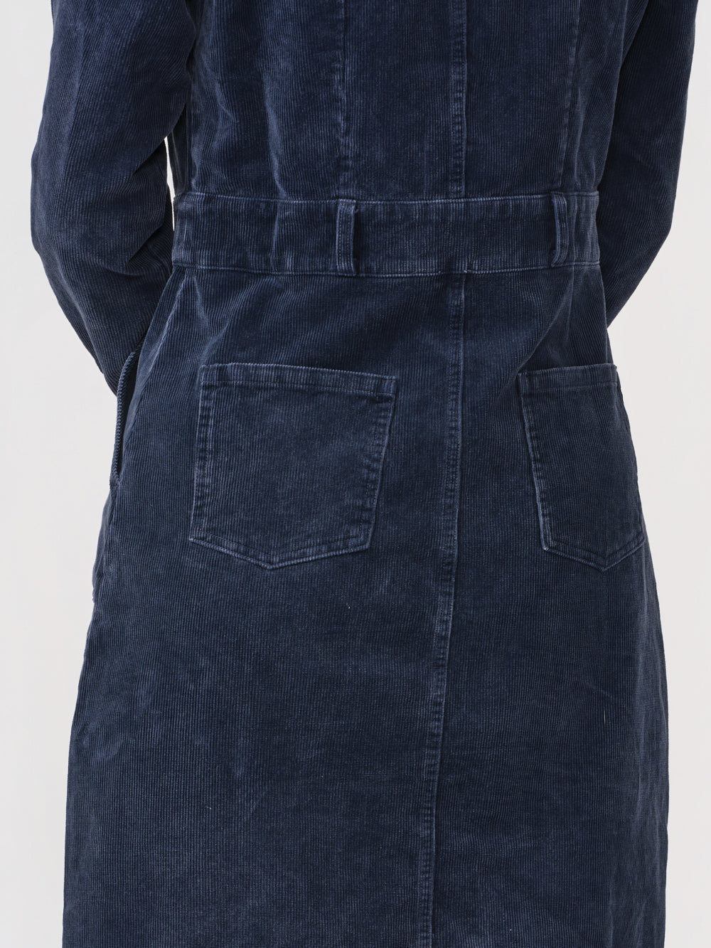 Close-up of the back waistband and patch pockets on the navy Odette cord dress
