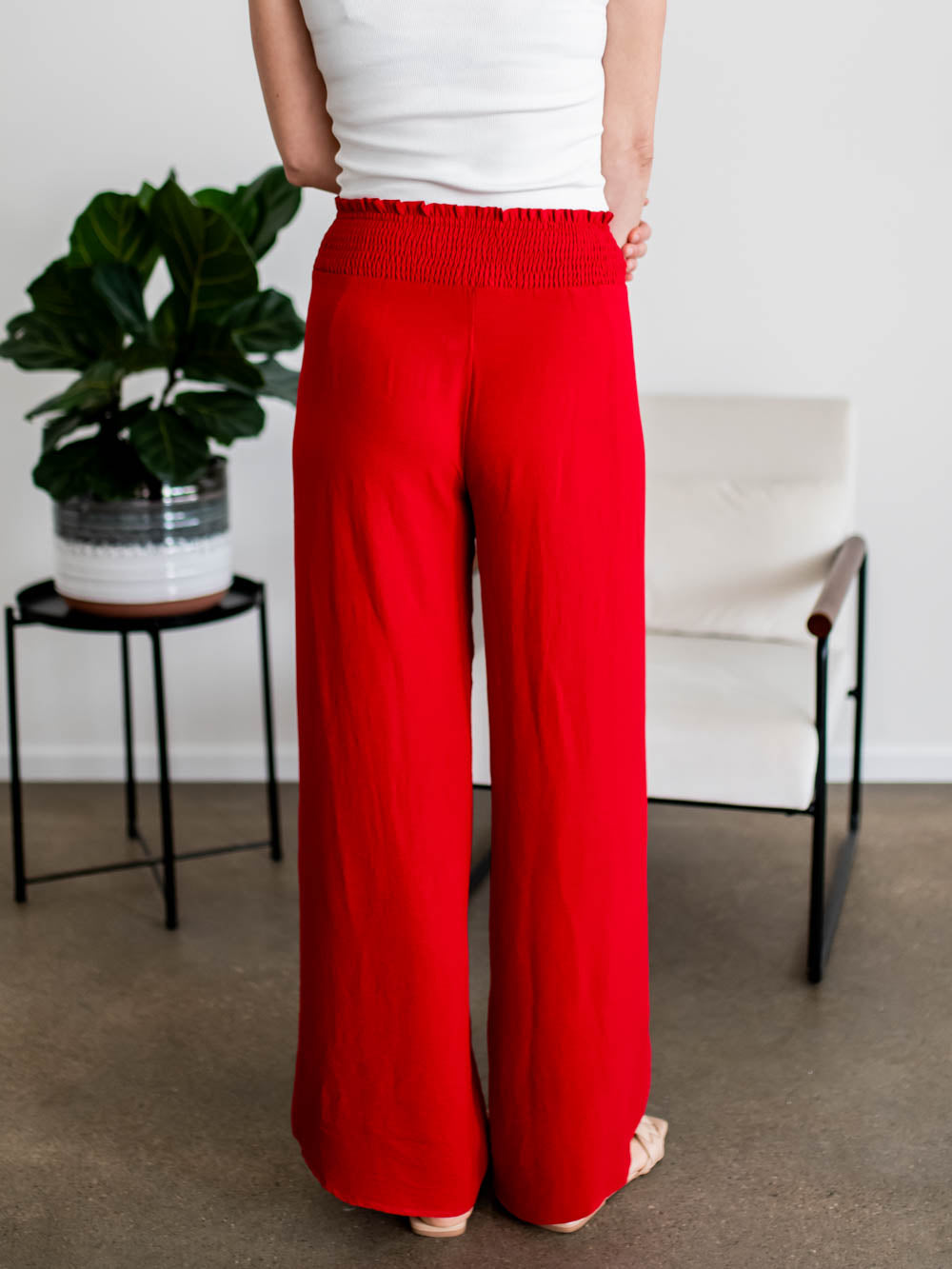 Back view of tall women’s culotte pants with smocked waistband and overlap detail